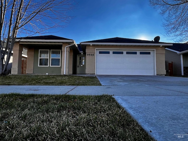 view of front of property featuring a garage and a front lawn