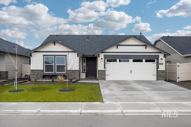 craftsman inspired home featuring a garage and a front yard