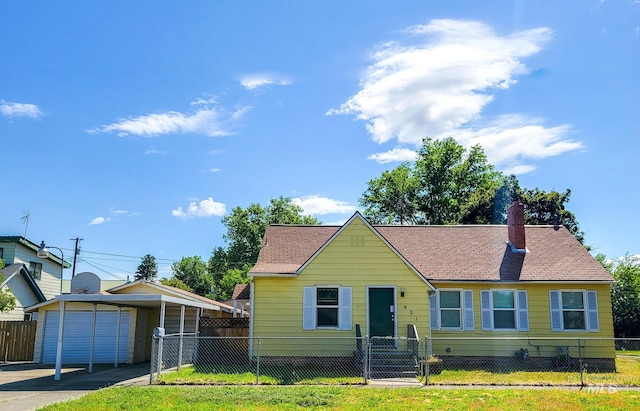 921 14th St, Lewiston, ID 83501 - view of front of home with a chimney, roof with shingles, driveway, and an outbuilding