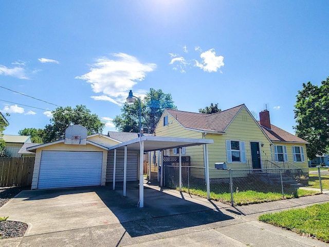 921 14th St, Lewiston, ID 83501 - view of front of house with driveway, a garage, an outbuilding, and a chimney