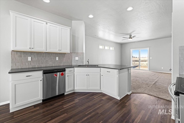 kitchen with white cabinetry, appliances with stainless steel finishes, sink, and kitchen peninsula