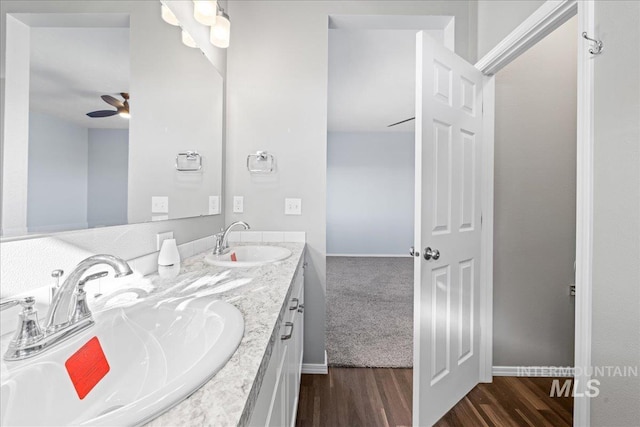 bathroom featuring wood-type flooring, vanity, and ceiling fan