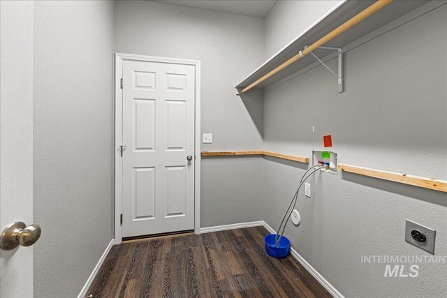 washroom featuring dark hardwood / wood-style floors, washer hookup, and hookup for an electric dryer