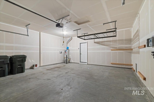 garage with a garage door opener and water heater