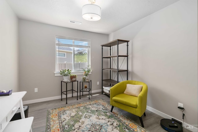 sitting room featuring baseboards and wood finished floors