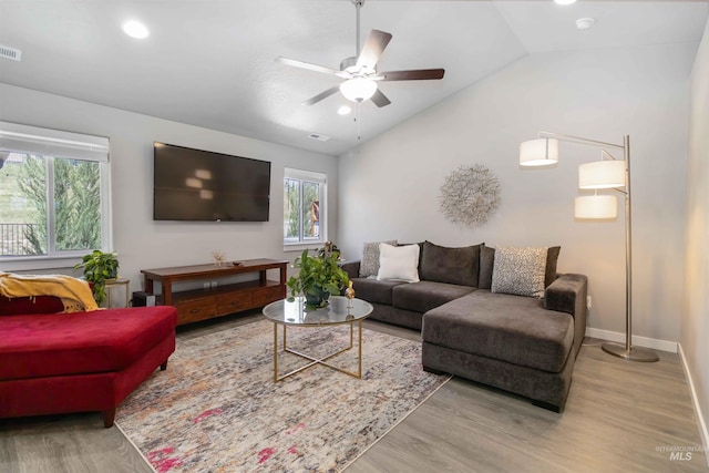 living room with lofted ceiling, plenty of natural light, wood finished floors, a ceiling fan, and recessed lighting