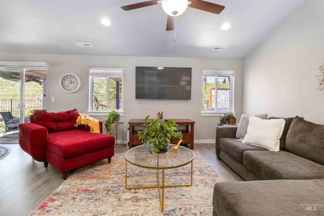 living room with healthy amount of natural light, wood finished floors, recessed lighting, and a ceiling fan