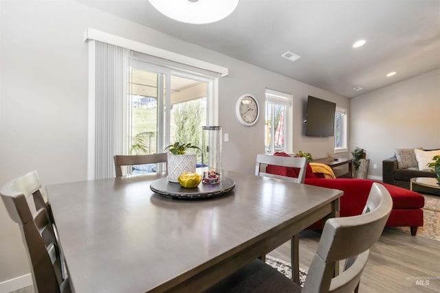 dining room with light wood-style flooring and recessed lighting
