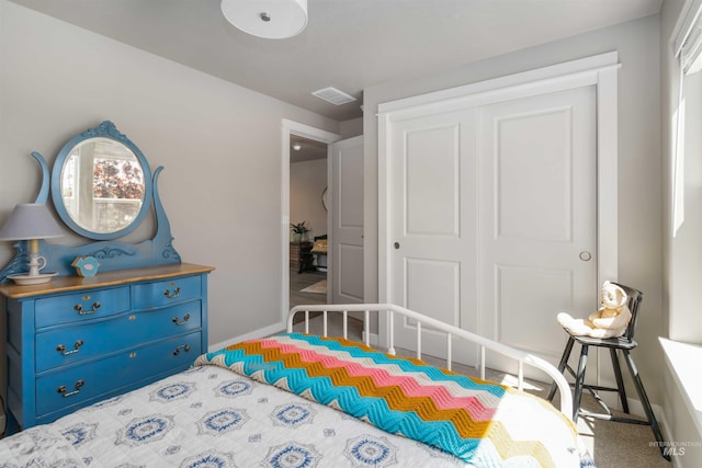 bedroom with a closet and baseboards