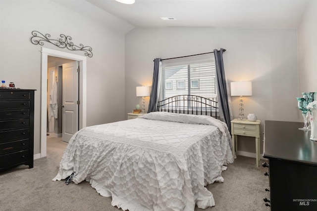 bedroom featuring carpet floors, lofted ceiling, and baseboards