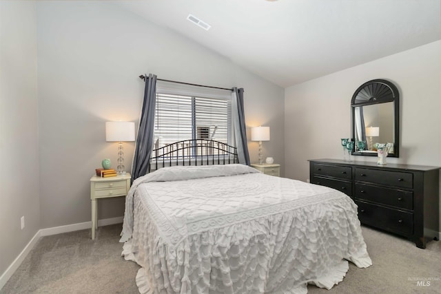bedroom featuring light carpet, lofted ceiling, and baseboards