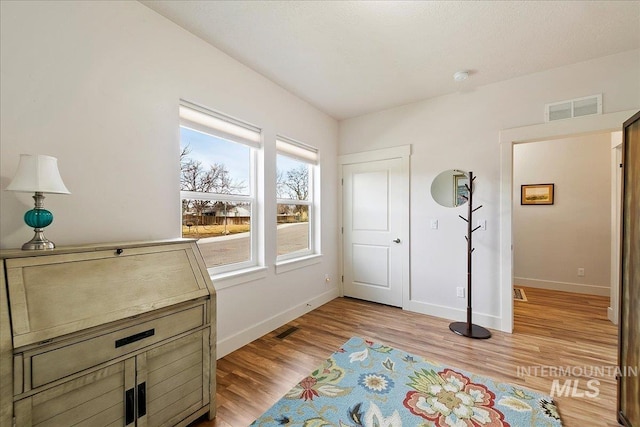 interior space featuring visible vents, baseboards, and light wood-style floors