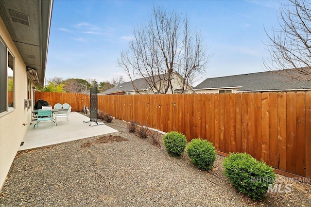 view of yard with a patio and a fenced backyard