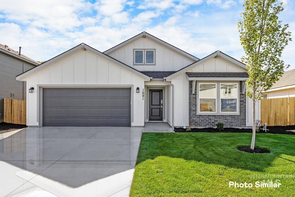 view of front of house with a garage and a front lawn