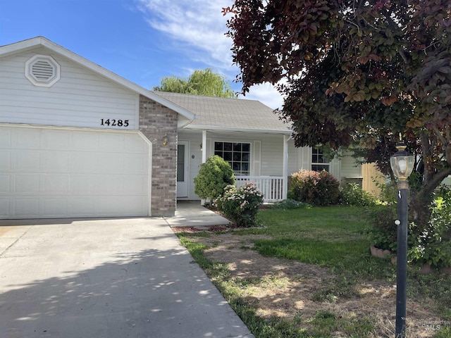 14285 Shenandoah St, Caldwell, ID 83607 - ranch-style home featuring a porch, concrete driveway, an attached garage, roof with shingles, and a front yard