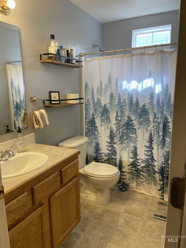 14285 Shenandoah St, Caldwell, ID 83607 - full bathroom featuring vanity, tile patterned floors, and a shower with shower curtain