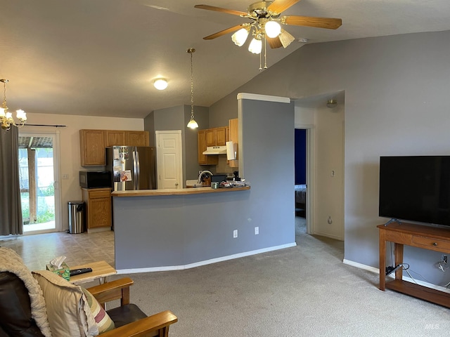 14285 Shenandoah St, Caldwell, ID 83607 - kitchen featuring freestanding refrigerator, under cabinet range hood, ceiling fan, light carpet, and a peninsula