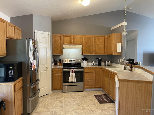 14285 Shenandoah St, Caldwell, ID 83607 - kitchen with appliances with stainless steel finishes, under cabinet range hood, vaulted ceiling, a peninsula, and tasteful backsplash