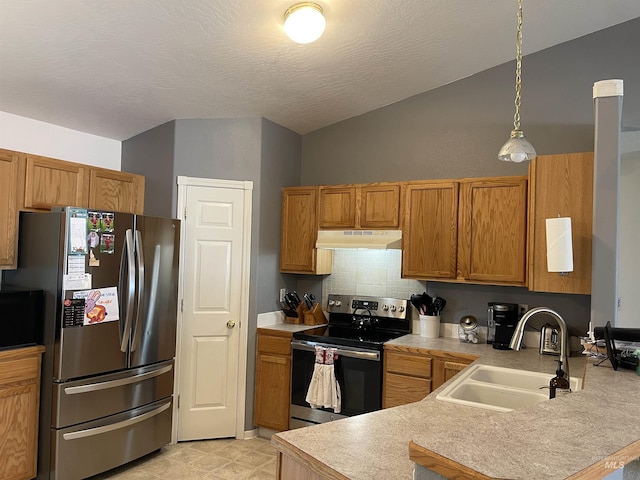 14285 Shenandoah St, Caldwell, ID 83607 - kitchen with appliances with stainless steel finishes, under cabinet range hood, lofted ceiling, a peninsula, and light countertops