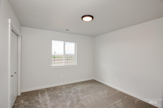 unfurnished bedroom featuring visible vents, baseboards, and carpet