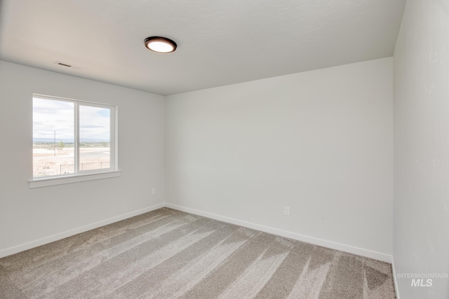 unfurnished room featuring visible vents, baseboards, and carpet floors