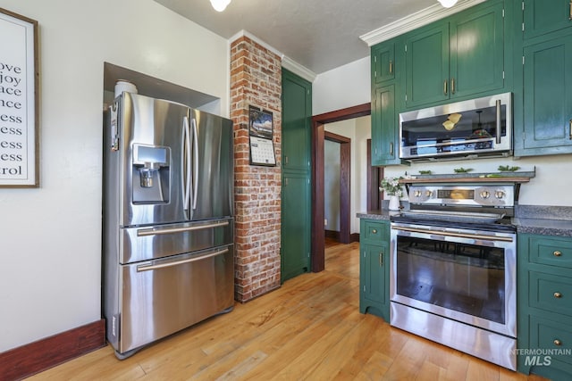 133 N Rd, Jerome, ID 83338 - kitchen featuring stainless steel appliances, light wood-style flooring, dark countertops, and green cabinetry
