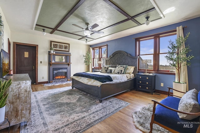 133 N Rd, Jerome, ID 83338 - bedroom with a glass covered fireplace, wood finished floors, baseboards, and ceiling fan