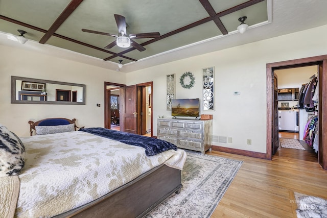 133 N Rd, Jerome, ID 83338 - bedroom featuring wood finished floors, a spacious closet, coffered ceiling, baseboards, and visible vents