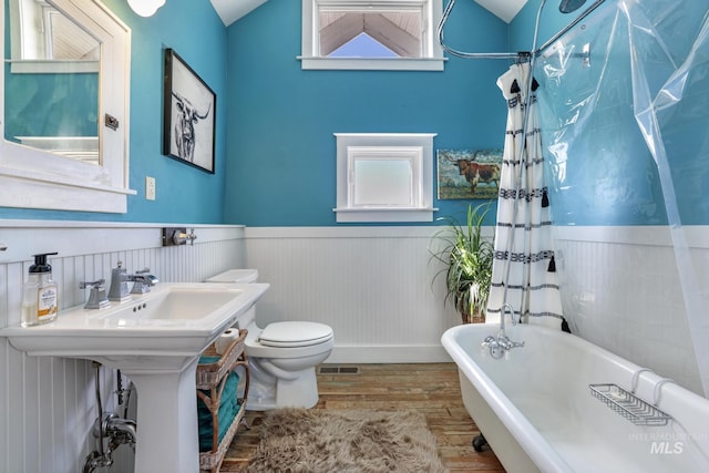 133 N Rd, Jerome, ID 83338 - bathroom with wainscoting, wood finished floors, a freestanding bath, and visible vents
