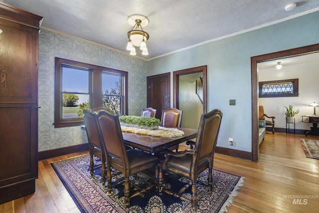 133 N Rd, Jerome, ID 83338 - dining area featuring baseboards, ornamental molding, wallpapered walls, and light wood finished floors