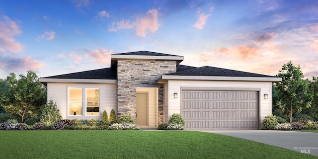 view of front of house featuring a garage and a yard