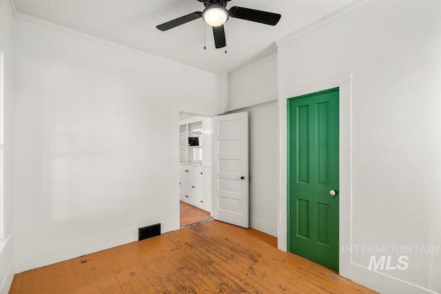 1045 N Beech Rd, Genesee, ID 83832 - unfurnished bedroom featuring wood finished floors, ornamental molding, visible vents, ceiling fan, and baseboards
