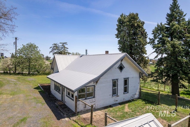 1045 N Beech Rd, Genesee, ID 83832 - view of home's exterior with a lawn, metal roof, and fence