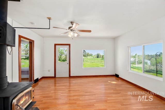 1045 N Beech Rd, Genesee, ID 83832 - interior space with a wealth of natural light, a wood stove, and light wood-type flooring