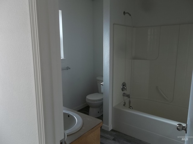 full bathroom with vanity, hardwood / wood-style flooring, bathing tub / shower combination, and toilet