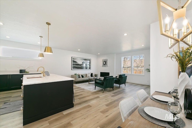 living room featuring sink and light hardwood / wood-style flooring