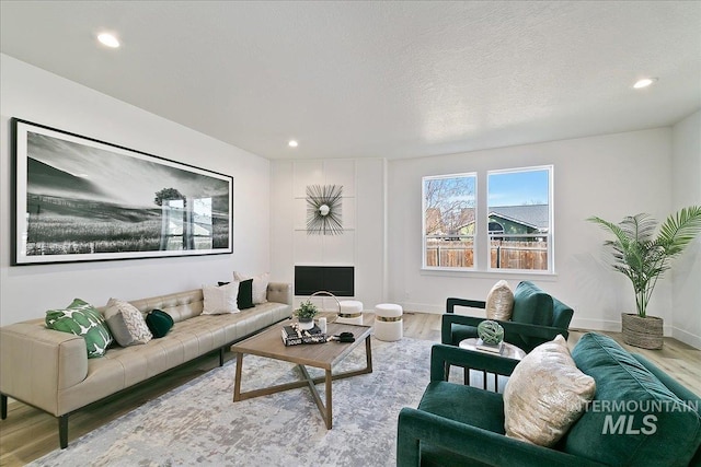 living room featuring hardwood / wood-style flooring and a textured ceiling