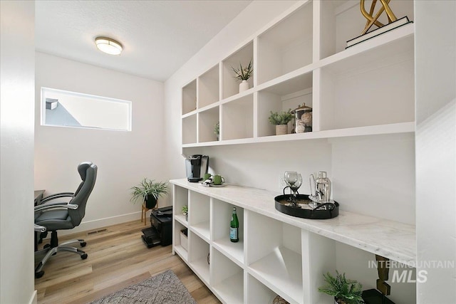 office with light hardwood / wood-style flooring