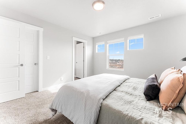 bedroom with baseboards, visible vents, and carpet flooring