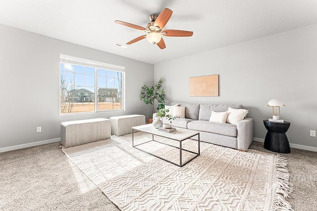 carpeted living room featuring baseboards, visible vents, and ceiling fan