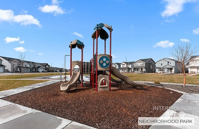 communal playground featuring a lawn and a residential view