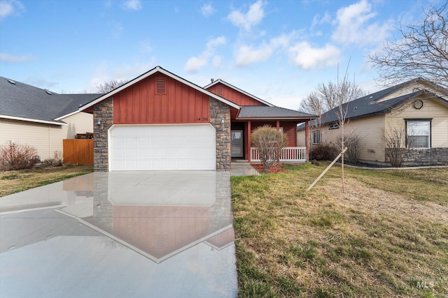 view of front facade with board and batten siding, a front lawn, a porch, concrete driveway, and an attached garage