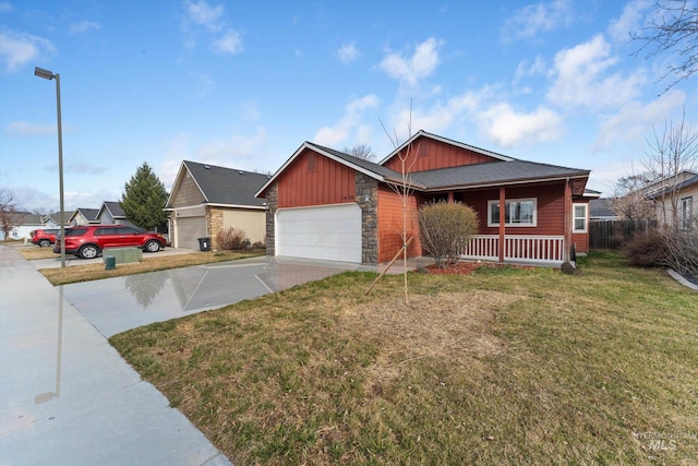 ranch-style home with a porch, concrete driveway, a front lawn, stone siding, and board and batten siding