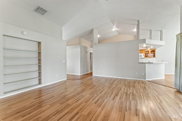 1728 S Labrador Pl, Meridian, ID 83642 - unfurnished living room featuring light wood-style floors, high vaulted ceiling, and built in features