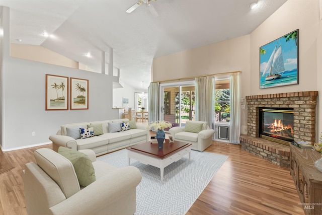 1728 S Labrador Pl, Meridian, ID 83642 - living area with light wood-style floors, a brick fireplace, ceiling fan, and high vaulted ceiling