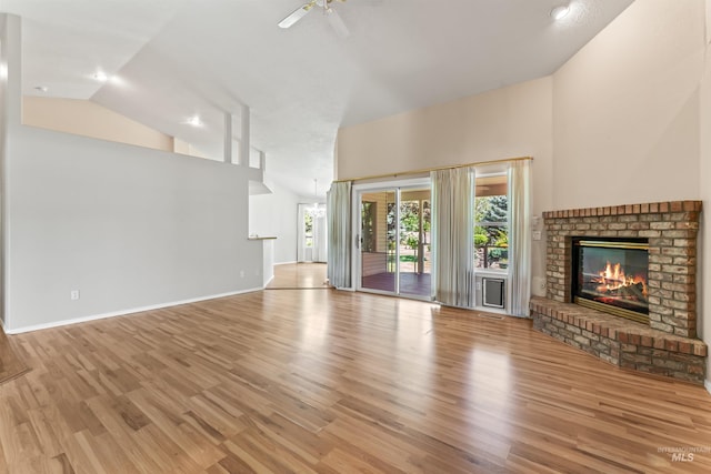 1728 S Labrador Pl, Meridian, ID 83642 - unfurnished living room featuring high vaulted ceiling, a brick fireplace, wood finished floors, and a ceiling fan