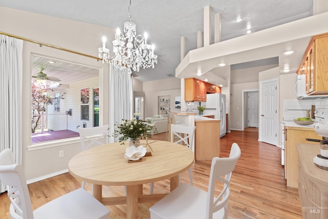 1728 S Labrador Pl, Meridian, ID 83642 - dining area with light wood finished floors, ceiling fan, and a chandelier