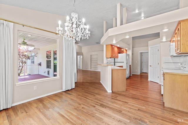 1728 S Labrador Pl, Meridian, ID 83642 - kitchen featuring white appliances, light wood-style floors, light countertops, backsplash, and decorative light fixtures