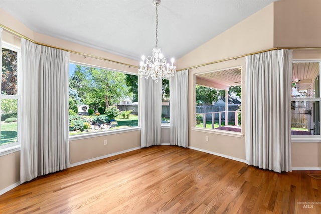 1728 S Labrador Pl, Meridian, ID 83642 - unfurnished dining area with a chandelier, wood finished floors, and vaulted ceiling