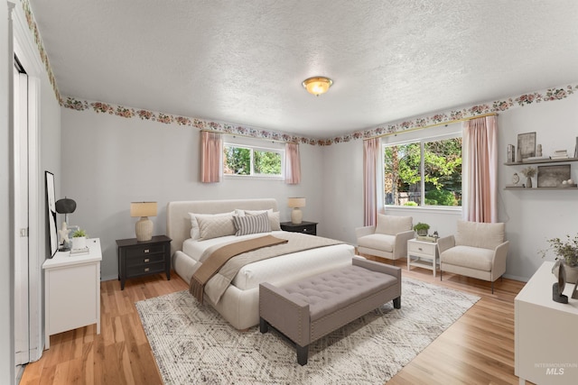 1728 S Labrador Pl, Meridian, ID 83642 - bedroom with a textured ceiling and light wood finished floors